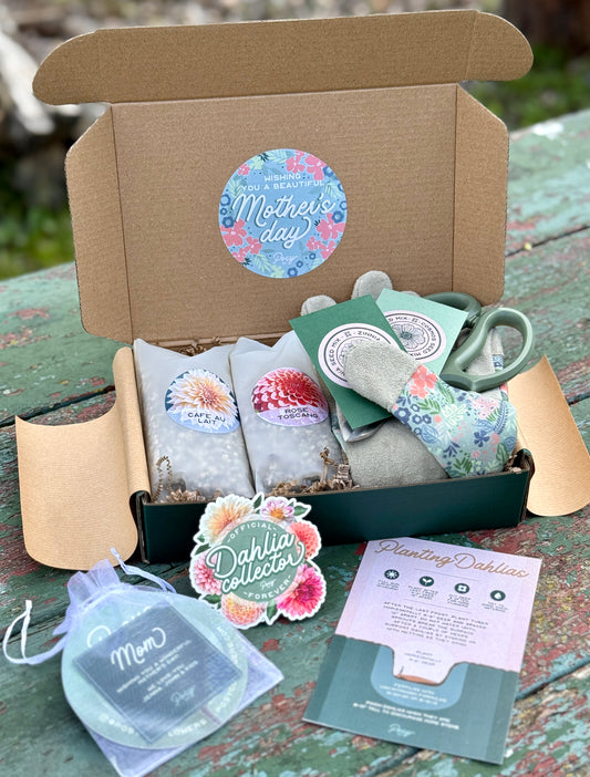 Box of gardening items with 'Mother's Day' sticker on a wooden surface